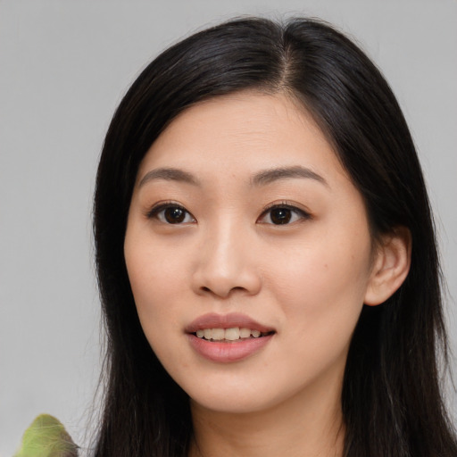 Joyful asian young-adult female with long  brown hair and brown eyes
