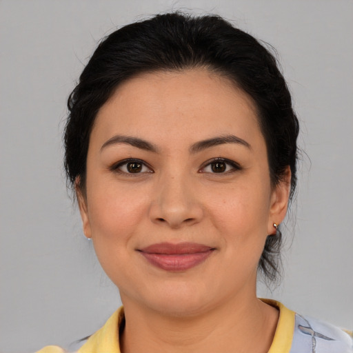Joyful latino young-adult female with medium  brown hair and brown eyes