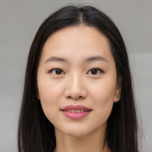 Joyful asian young-adult female with long  brown hair and brown eyes