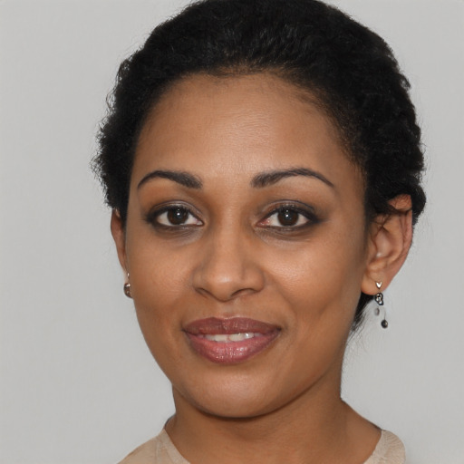 Joyful black young-adult female with short  black hair and brown eyes