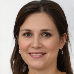 Joyful white adult female with long  brown hair and grey eyes