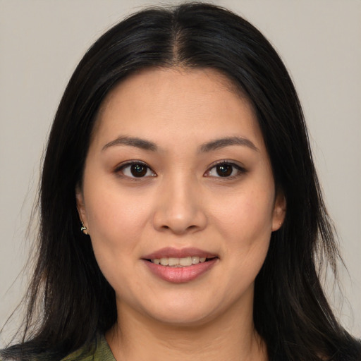 Joyful asian young-adult female with long  brown hair and brown eyes