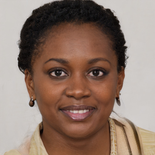 Joyful black young-adult female with short  brown hair and brown eyes