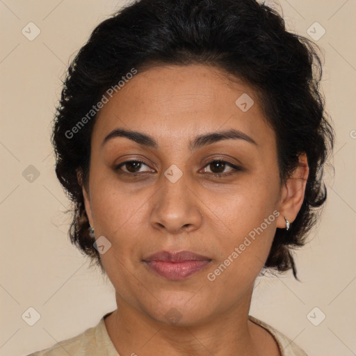 Joyful latino adult female with medium  brown hair and brown eyes