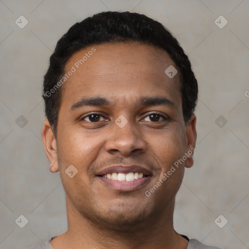 Joyful black young-adult male with short  brown hair and brown eyes