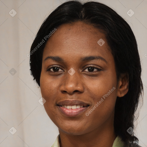 Joyful black young-adult female with long  black hair and brown eyes