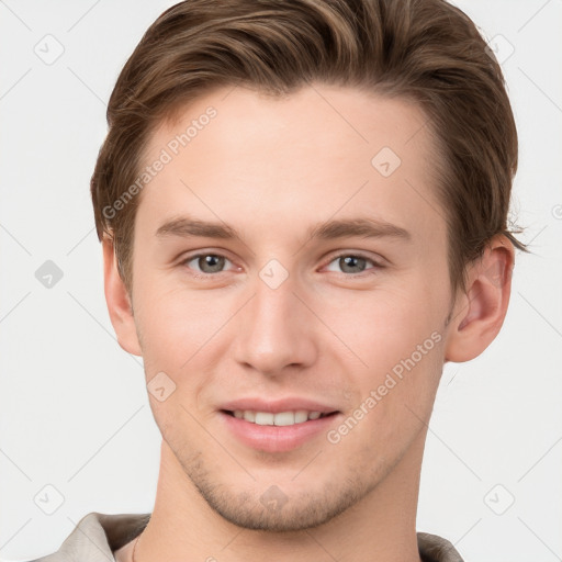 Joyful white young-adult male with short  brown hair and grey eyes