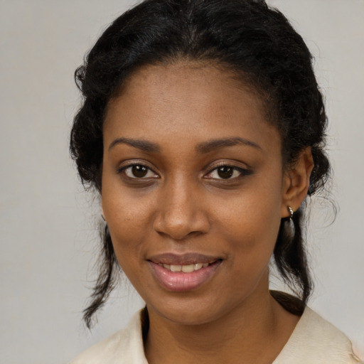 Joyful black young-adult female with medium  brown hair and brown eyes