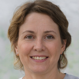 Joyful white adult female with medium  brown hair and grey eyes