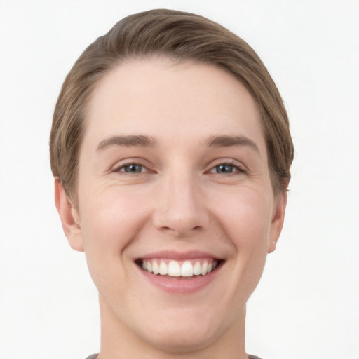 Joyful white young-adult female with short  brown hair and grey eyes