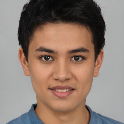 Joyful latino young-adult male with short  brown hair and brown eyes