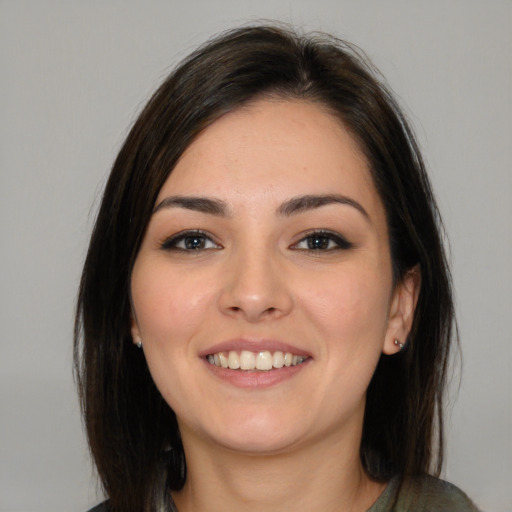 Joyful white young-adult female with medium  brown hair and brown eyes