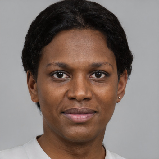 Joyful black young-adult female with short  black hair and brown eyes