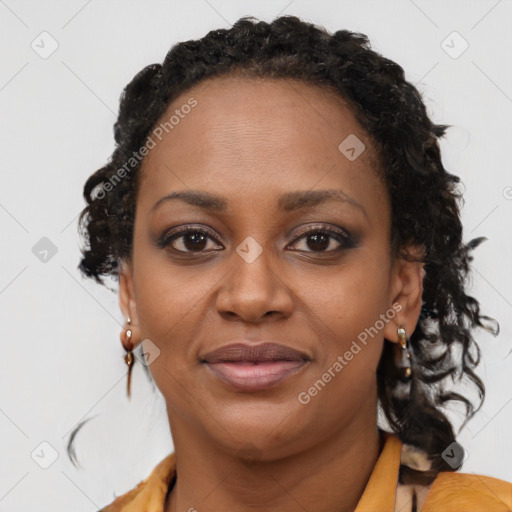 Joyful black young-adult female with long  brown hair and brown eyes