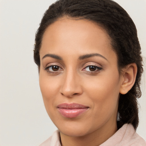 Joyful latino young-adult female with long  brown hair and brown eyes