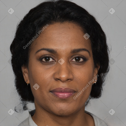 Joyful black adult female with medium  brown hair and brown eyes