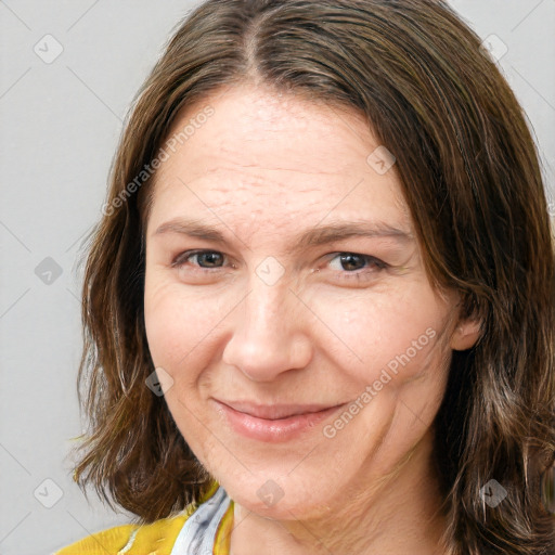 Joyful white adult female with medium  brown hair and brown eyes