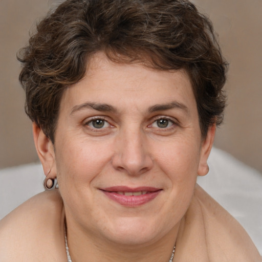 Joyful white adult female with short  brown hair and brown eyes