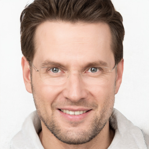 Joyful white adult male with short  brown hair and grey eyes