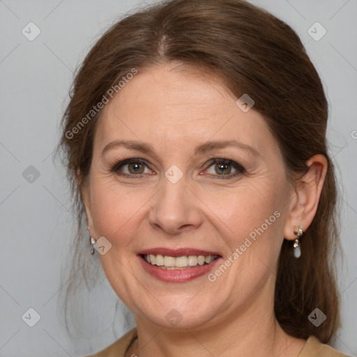 Joyful white adult female with medium  brown hair and grey eyes