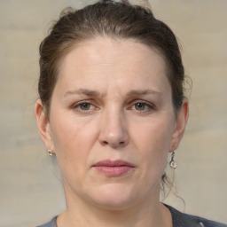 Joyful white adult female with medium  brown hair and grey eyes