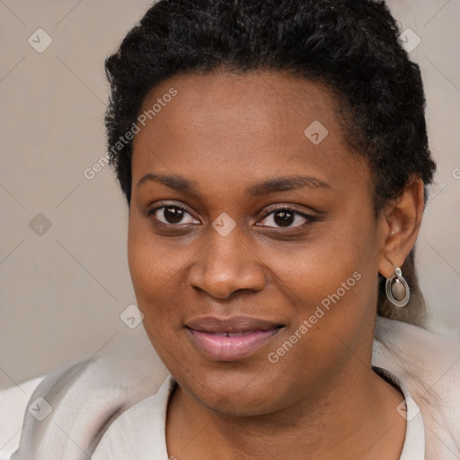 Joyful black young-adult female with short  black hair and brown eyes