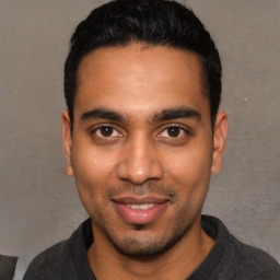 Joyful white young-adult male with short  black hair and brown eyes