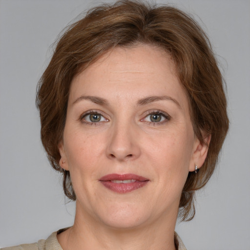 Joyful white adult female with medium  brown hair and grey eyes