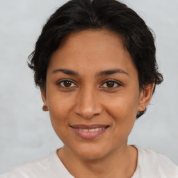 Joyful latino young-adult female with short  brown hair and brown eyes