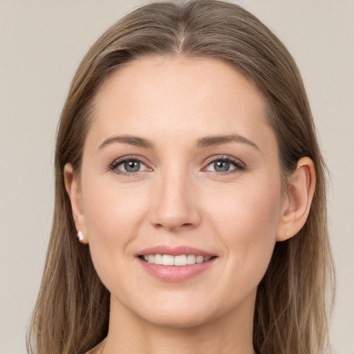 Joyful white young-adult female with long  brown hair and grey eyes