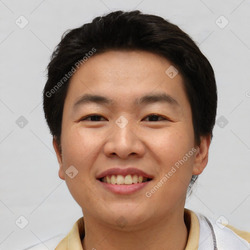 Joyful asian young-adult male with short  brown hair and brown eyes