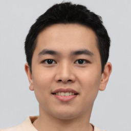 Joyful asian young-adult male with short  black hair and brown eyes