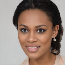 Joyful black young-adult female with long  brown hair and brown eyes