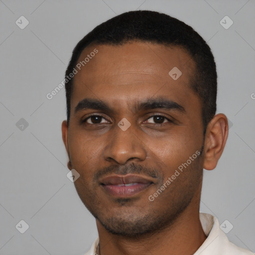 Joyful black young-adult male with short  black hair and brown eyes