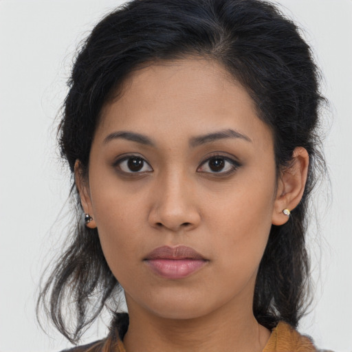 Joyful latino young-adult female with medium  brown hair and brown eyes