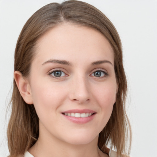 Joyful white young-adult female with long  brown hair and blue eyes