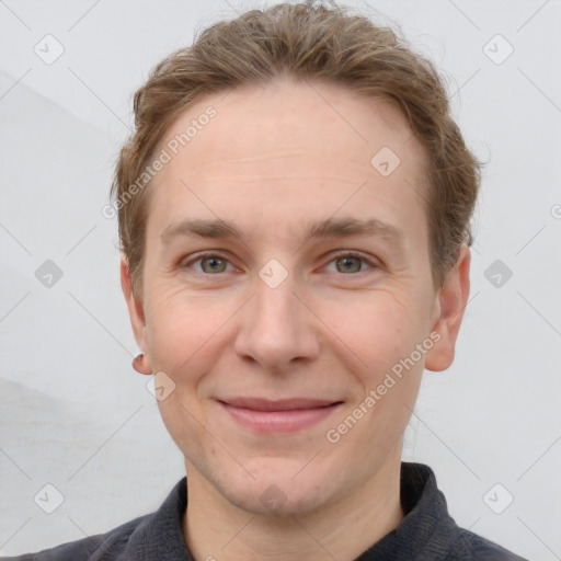 Joyful white adult male with short  brown hair and grey eyes