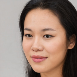 Joyful asian young-adult female with long  brown hair and brown eyes