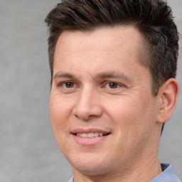 Joyful white adult male with short  brown hair and brown eyes