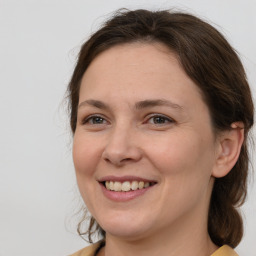 Joyful white adult female with medium  brown hair and brown eyes