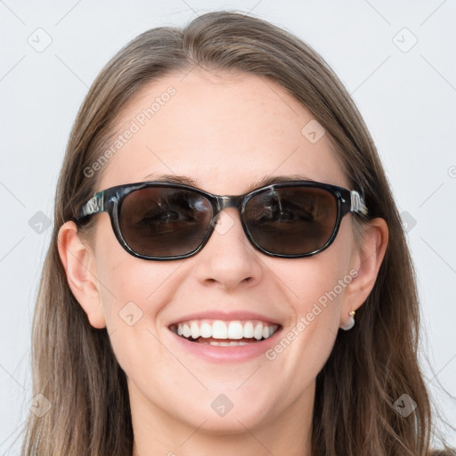 Joyful white young-adult female with long  brown hair and blue eyes