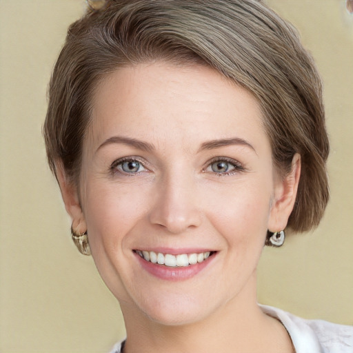 Joyful white young-adult female with short  brown hair and grey eyes