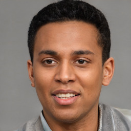 Joyful latino young-adult male with short  black hair and brown eyes