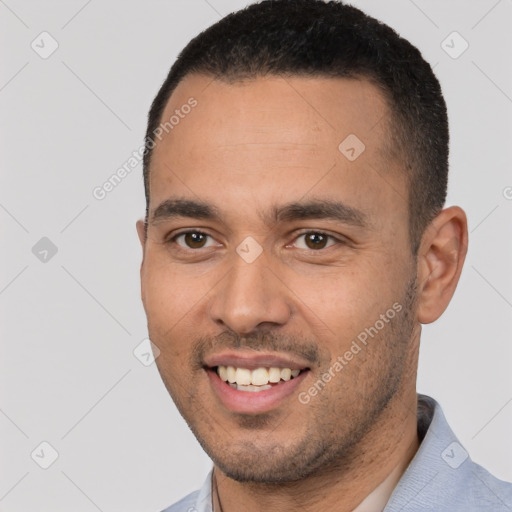 Joyful white young-adult male with short  black hair and brown eyes