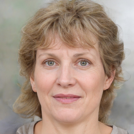 Joyful white adult female with medium  brown hair and blue eyes