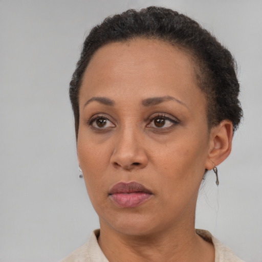 Neutral latino adult female with short  brown hair and brown eyes