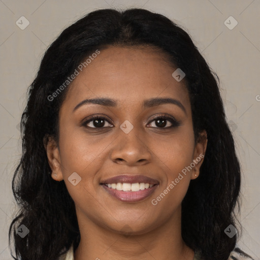 Joyful black young-adult female with long  brown hair and brown eyes