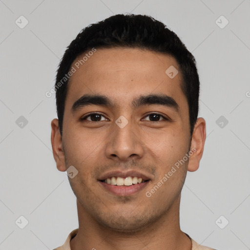 Joyful latino young-adult male with short  black hair and brown eyes