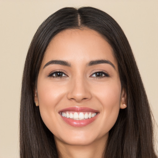 Joyful white young-adult female with long  brown hair and brown eyes