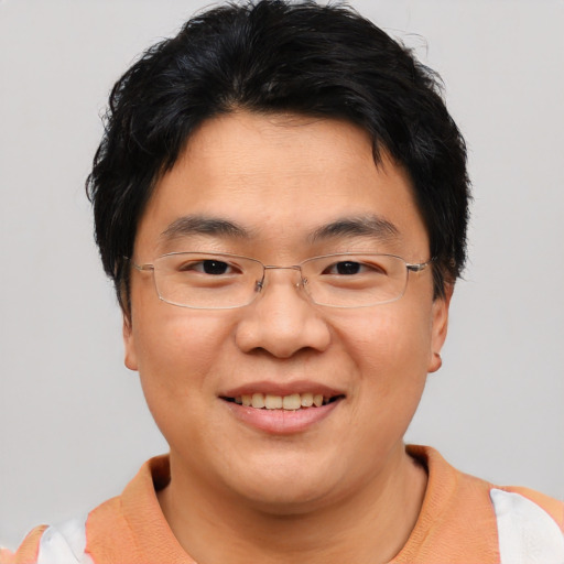 Joyful asian young-adult male with short  brown hair and brown eyes